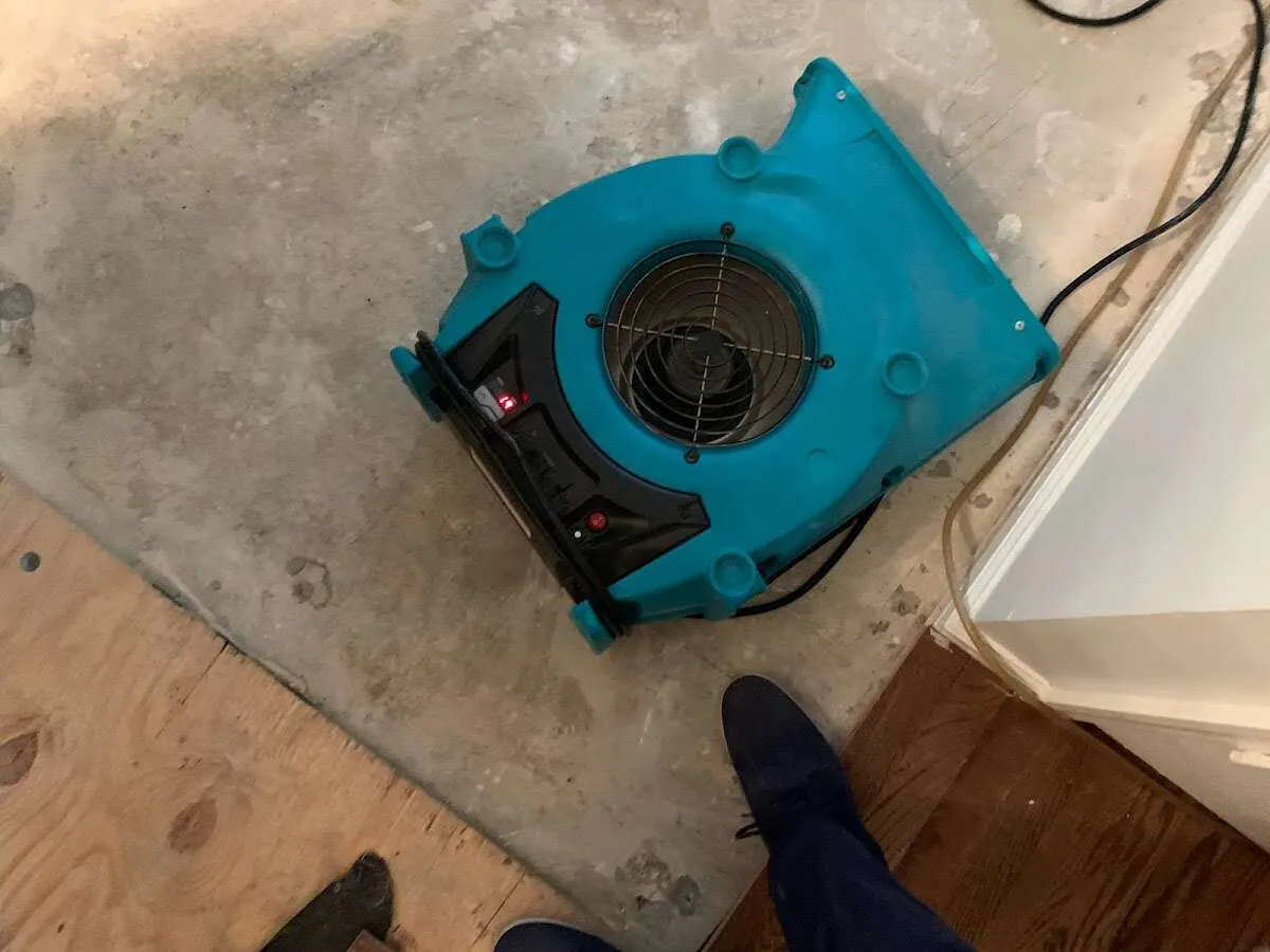 Air mover drying subfloor during Commercial Water Damage Restoration in Woodward